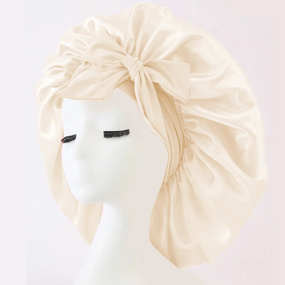 Cream adjustable satin bonnet for sleeping with large bow detail by Sacred Self Wellness