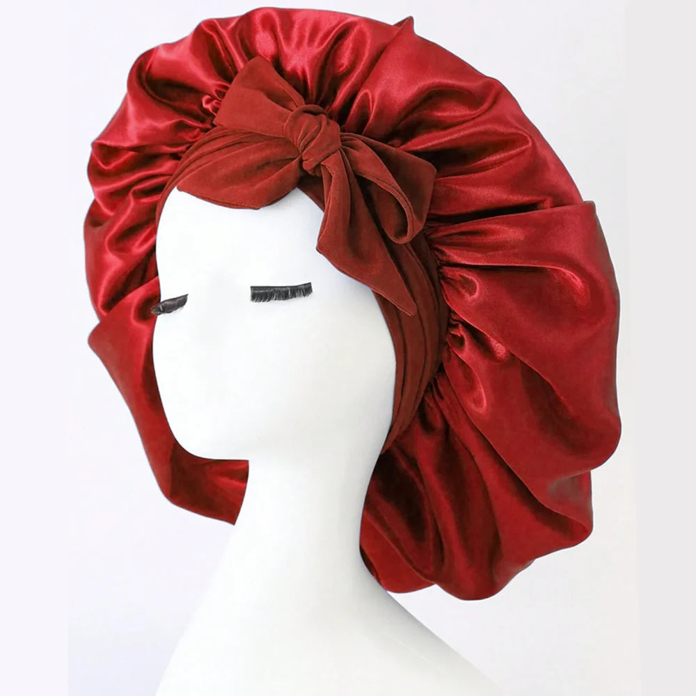 Adjustable satin bonnet for sleeping in deep red with a bow detail by SACRED SELF WELLNESS