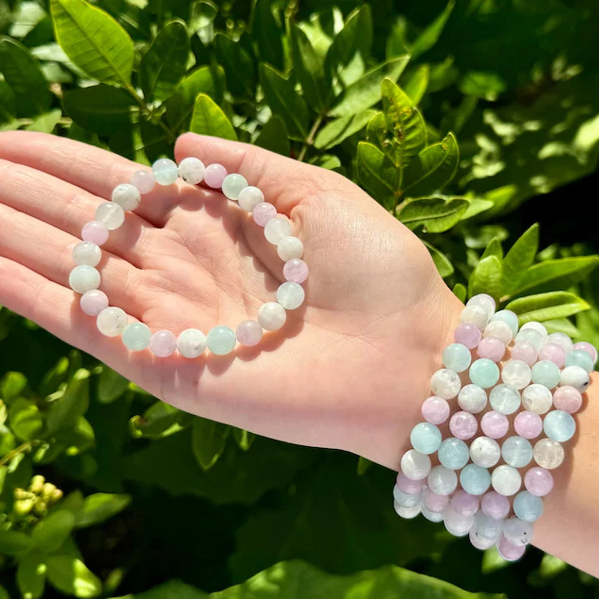 Crystal bracelet for mindfulness practice with pastel-colored round beads held in hand outdoors