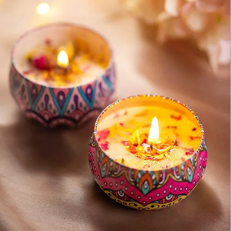 Two burning Islamic pattern scented candles in colorful decorative holders on a soft surface