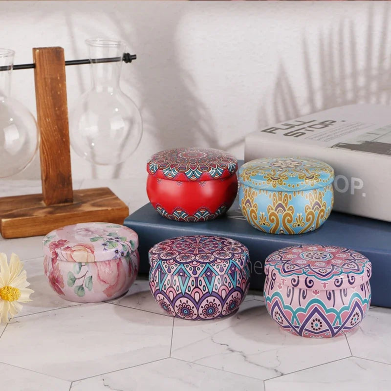 Five decorative Islamic pattern scented candles in colorful patterned tins on marble surface