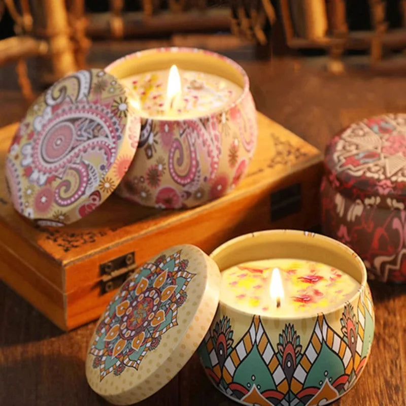 Islamic pattern scented candles in decorative tins with intricate designs and lit wicks on wooden surface
