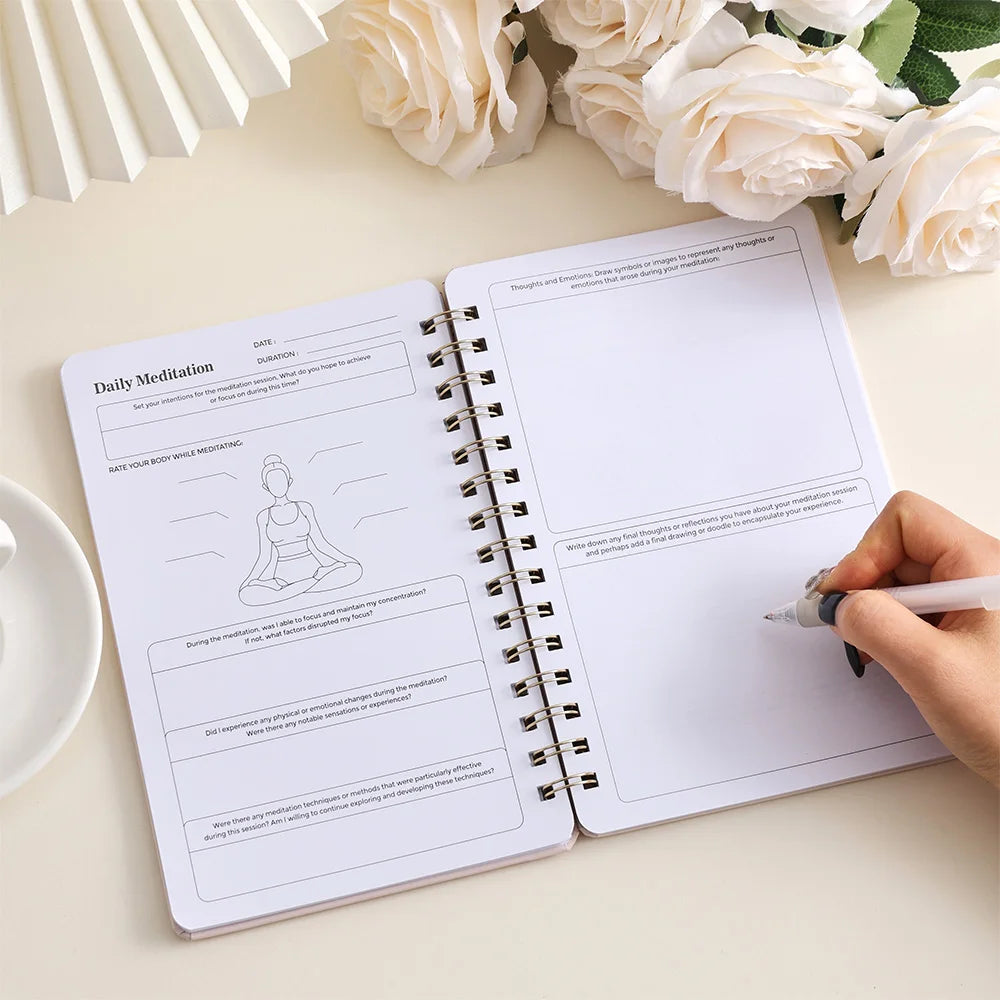 Meditation journal for mindfulness by SACRED SELF WELLNESS open on a desk with handwritten notes and floral decor