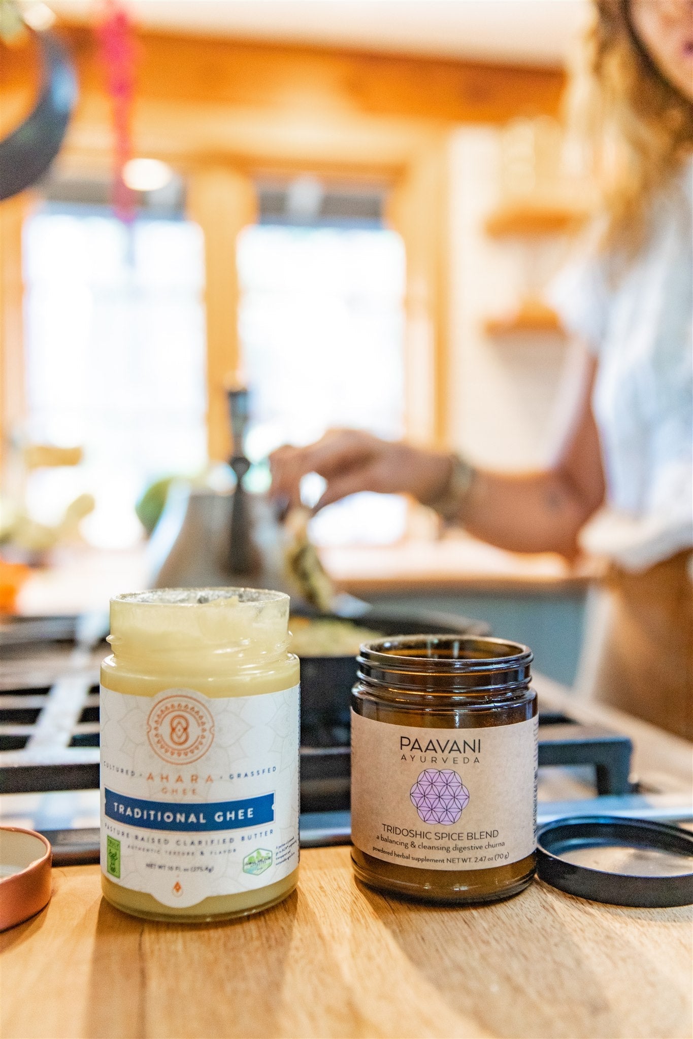 DC-PAAVANI Ayurveda tridoshic spice blend jar next to traditional ghee jar on kitchen counter