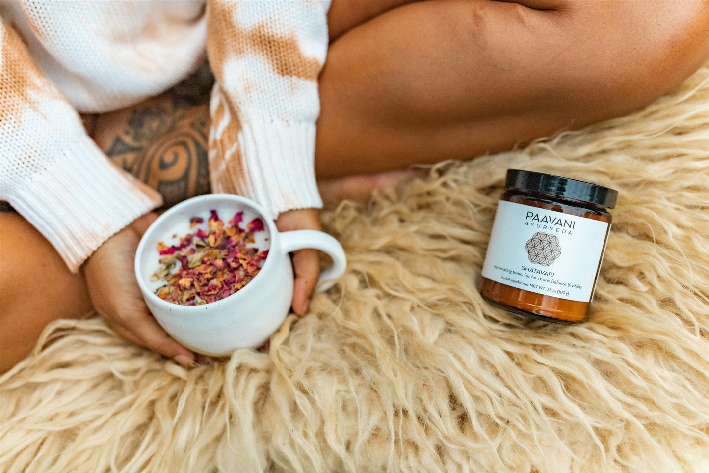 Ayurvedic tonic for daily wellness by DC-PAAVANI Ayurveda with a cup of herbal tea and dried rose petals