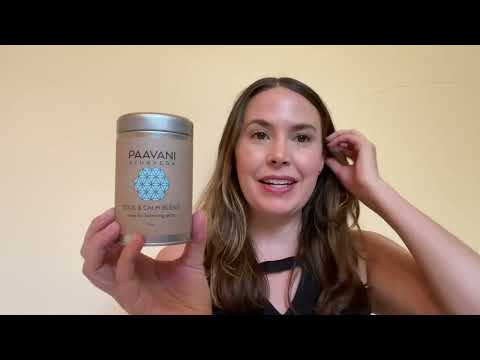 Woman holding DC-PAAVANI Ayurveda herbal tea ritual set container with natural ingredients label