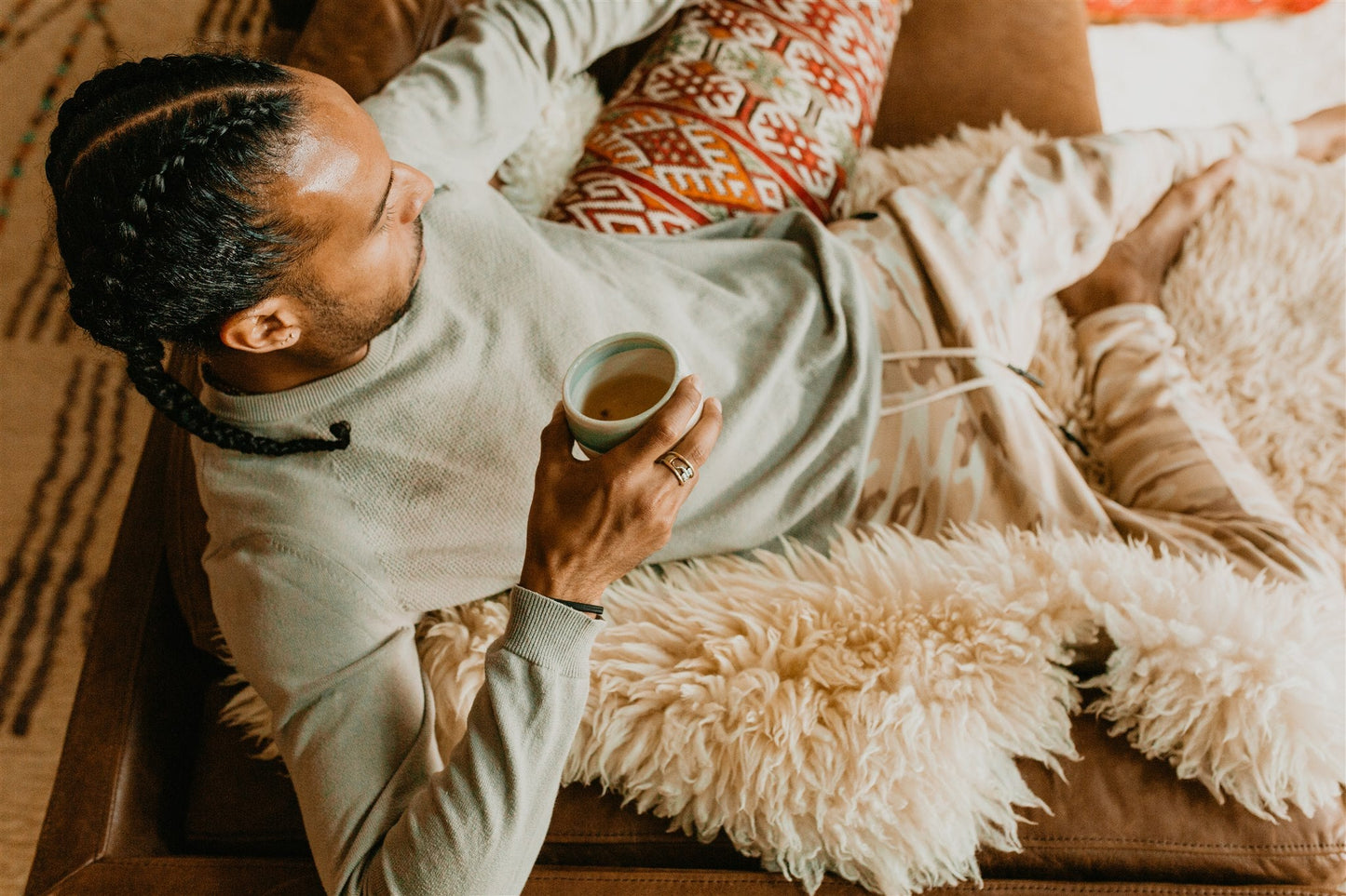 Man relaxing with a cup of tea enjoying the benefits of Vata spice blend for digestion by DC-PAAVANI Ayurveda