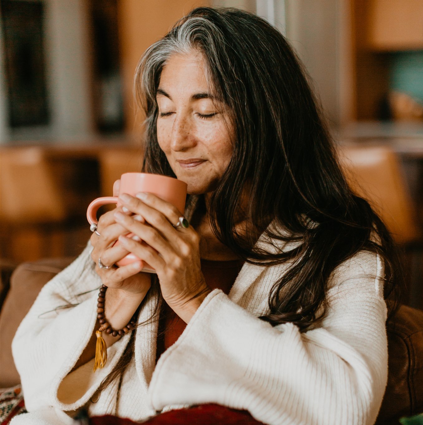 Peaceful woman enjoying a warm drink highlighting Ayurvedic consultations online by DC-PAAVANI Ayurveda
