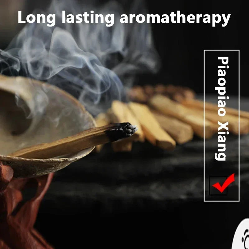 Burning palo santo incense sticks producing smoke for long lasting aromatherapy by Sacred Self Wellness