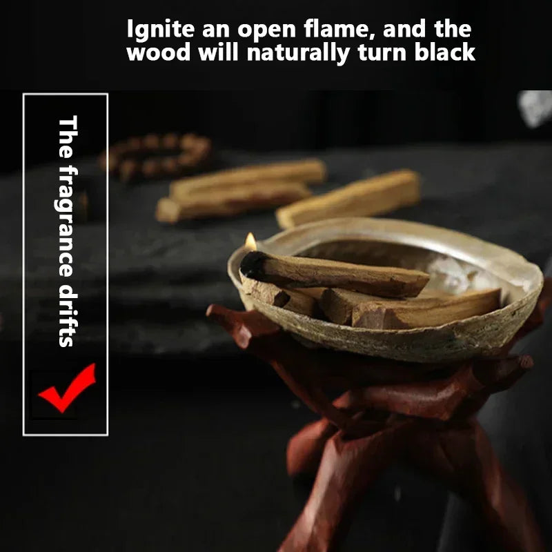 Burning palo santo incense sticks on a wooden holder with glowing flame and natural fragrance