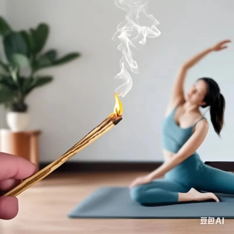 Burning palo santo incense sticks held near a woman practicing yoga on a mat at home