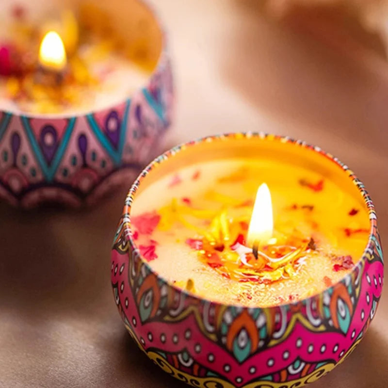 Lit Islamic pattern scented candles in colorful holders with intricate geometric designs on wooden surface