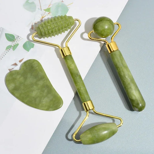 Green jade roller and gua sha set with gold accents for facial massage and skincare