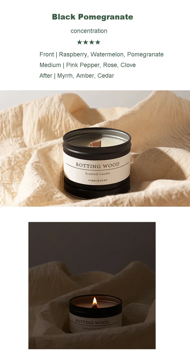 Black Pomegranate scented candle with dried flowers in black jar on beige fabric