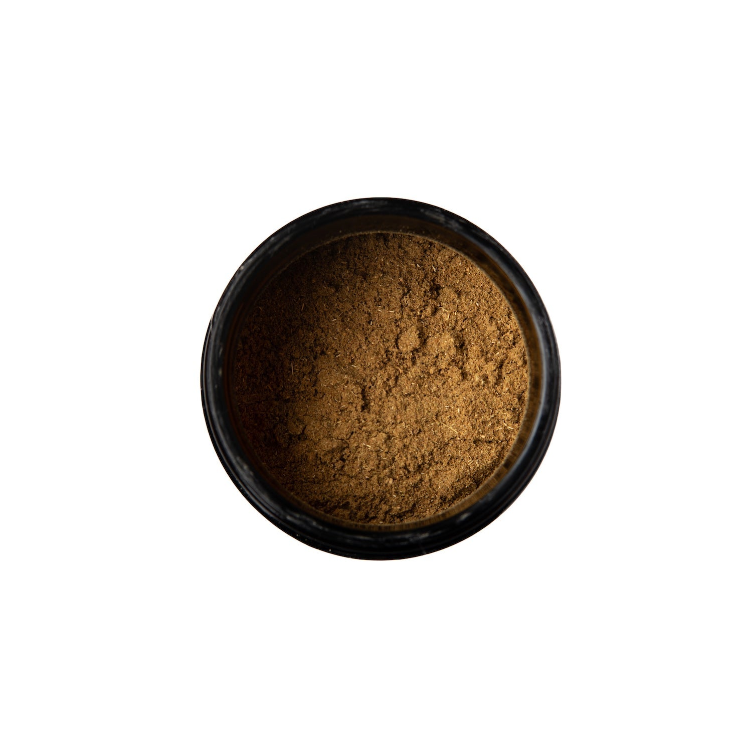 Top view of tridoshic spice blend powder in a small black bowl by DC-PAAVANI Ayurveda