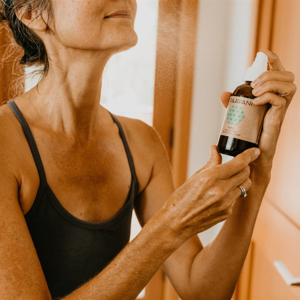Woman using DC-PAAVANI Ayurveda spray from vata facial ritual set for refreshing skincare