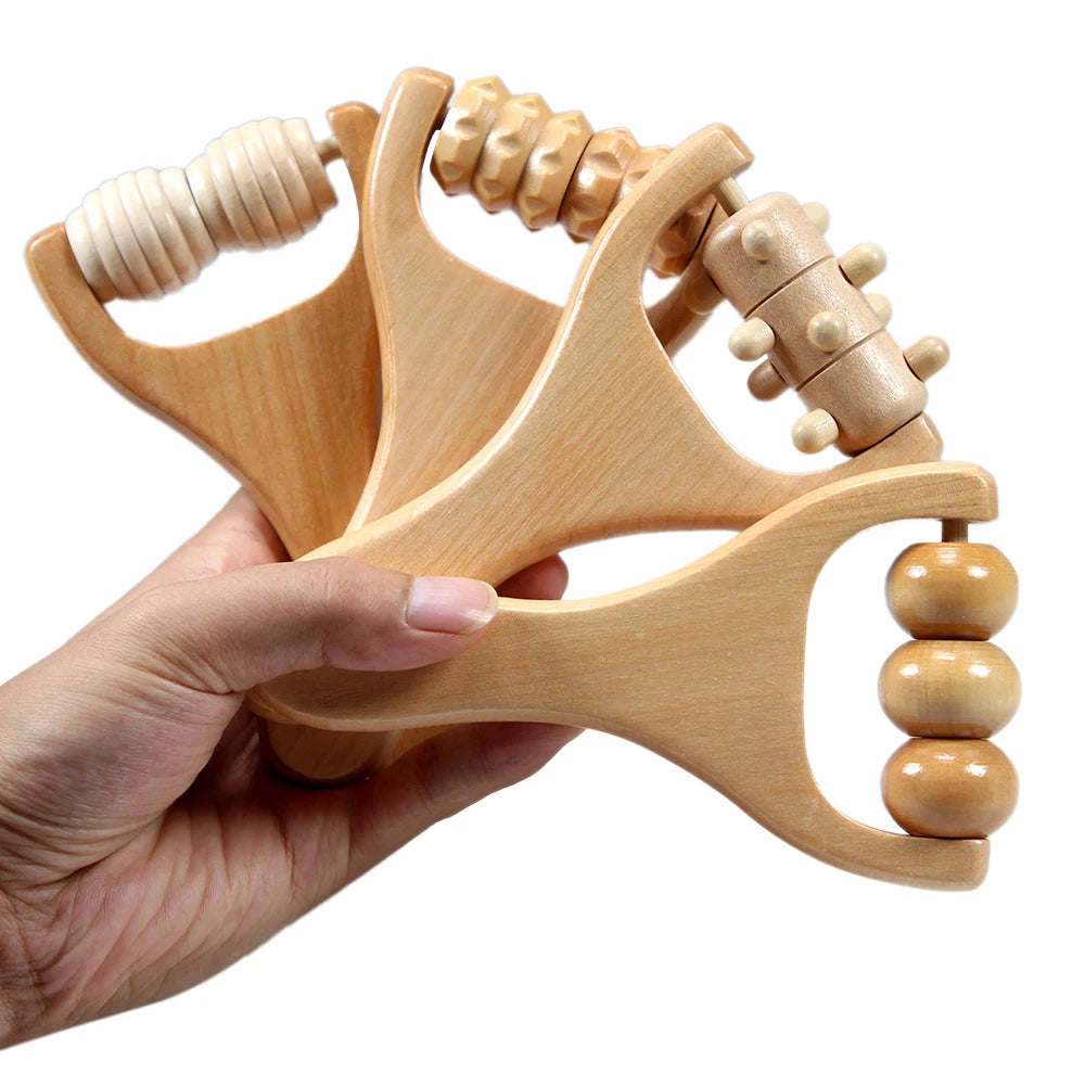 Hand holding four wooden handheld massage rollers with different textured rollers for muscle relief